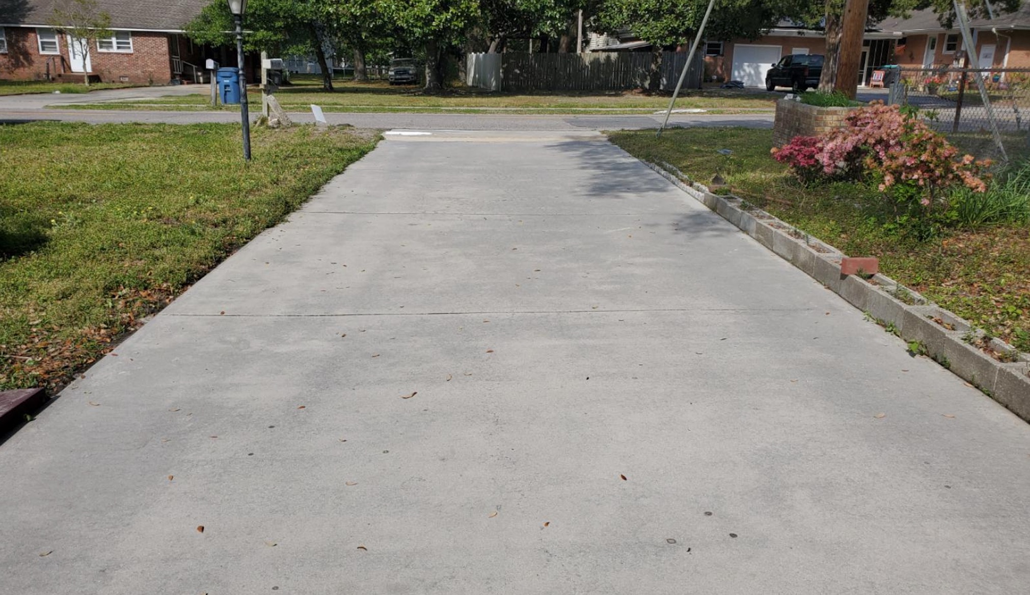 After: Long residential driveway before and after professional cleaning