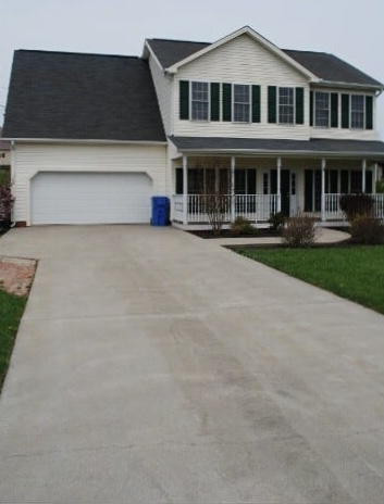 After: Suburban home driveway before and after pressure washing