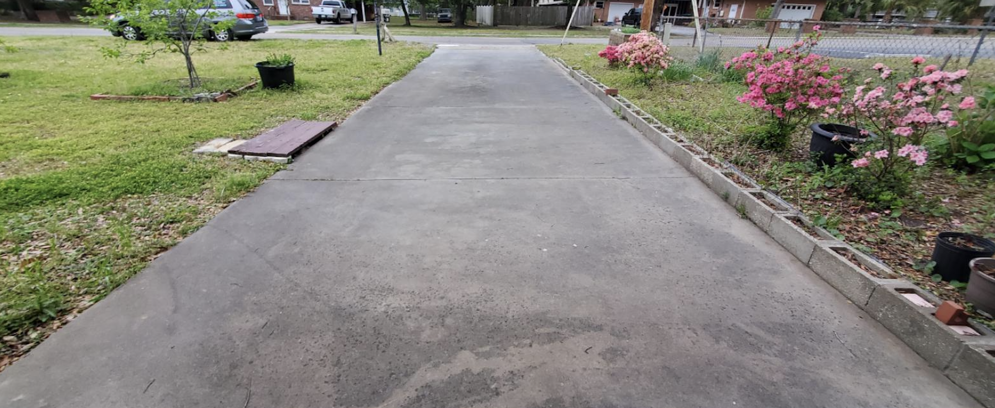 Before: Long residential driveway before and after professional cleaning