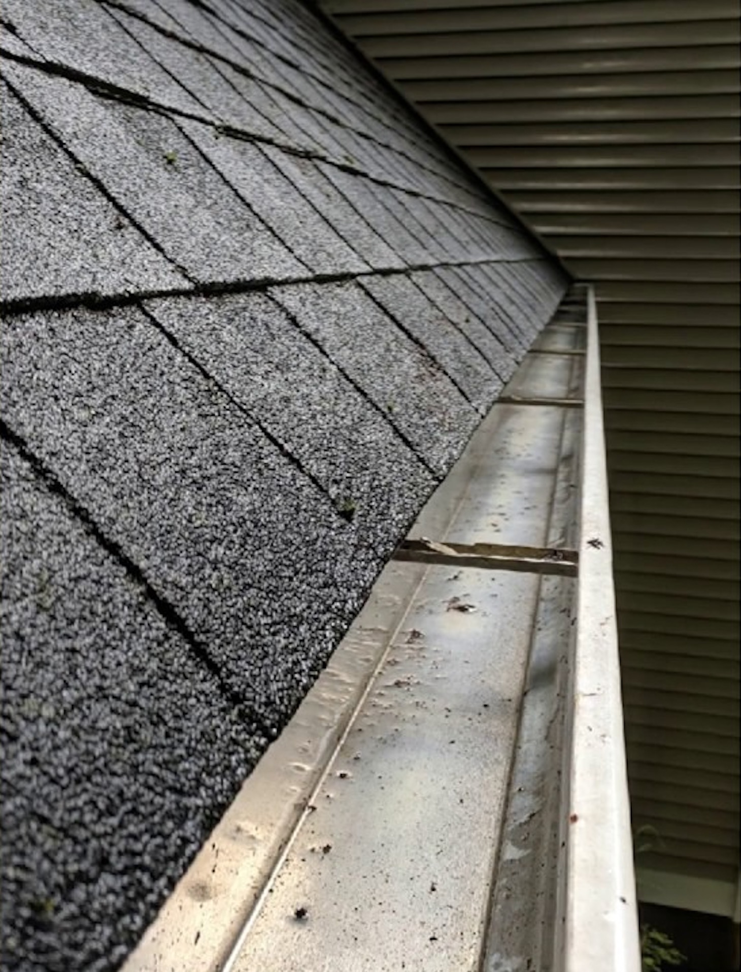 After: Gutter clogged with debris before and after cleaning