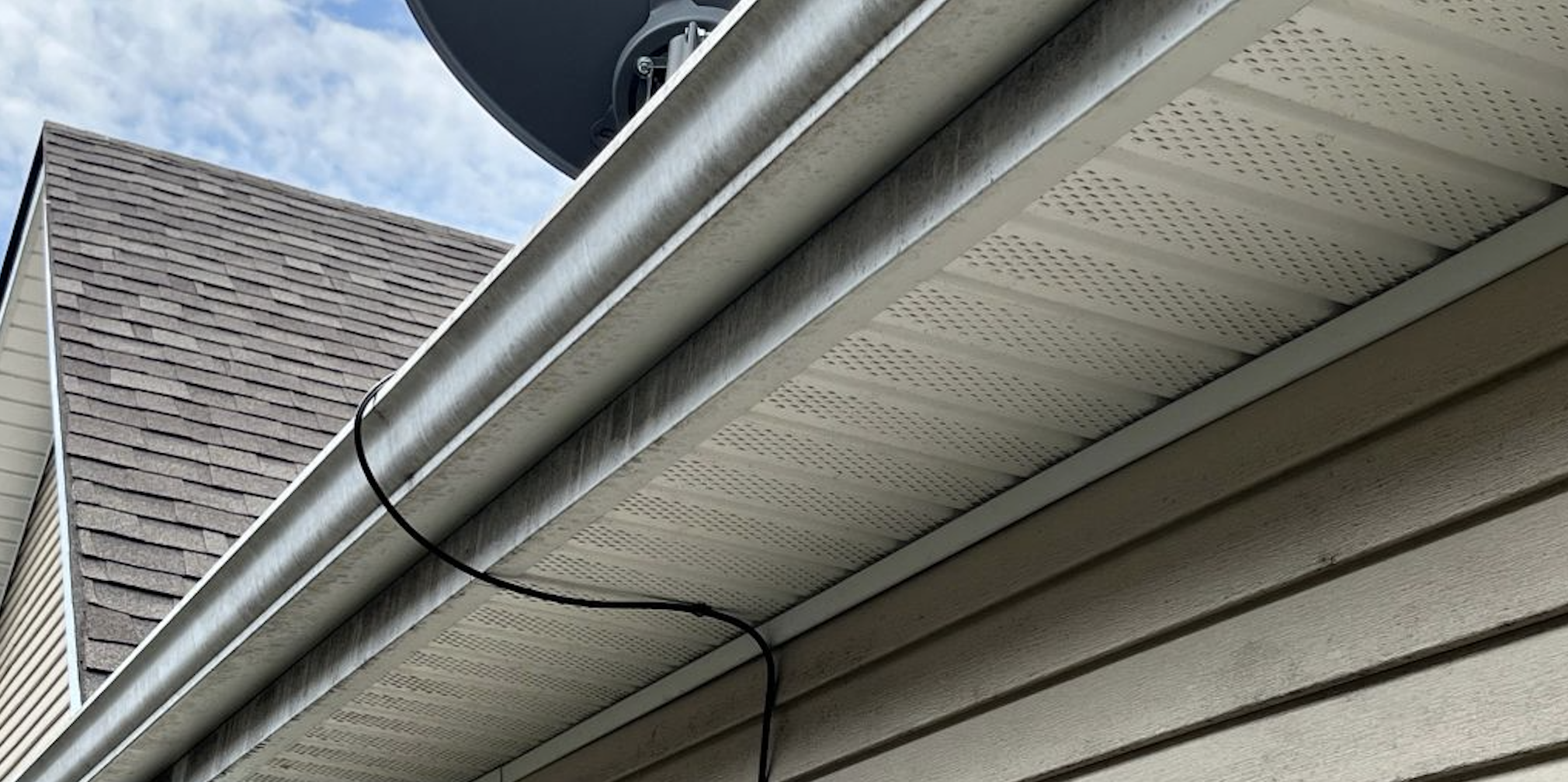 Before: Dirty gutter exterior before and after cleaning
