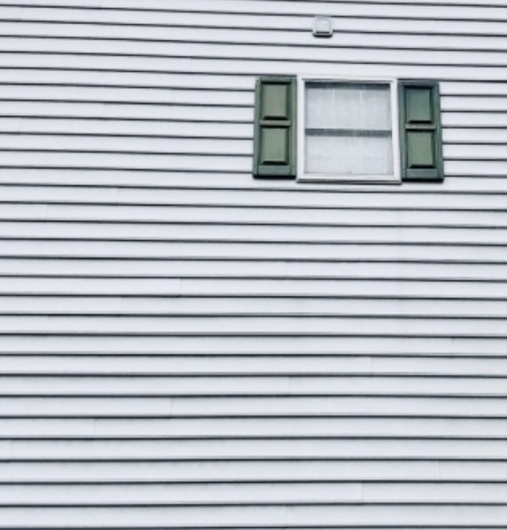 After: Siding with window and shutters before and after soft washing